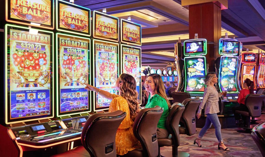 Two women playing slot machines